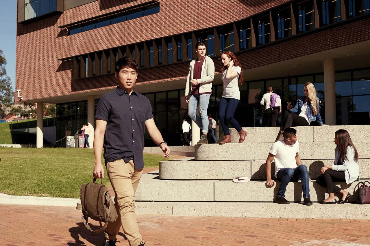 Students spending time outside a modern Australian university building
